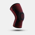 Black knee brace with red accents on a light gray background